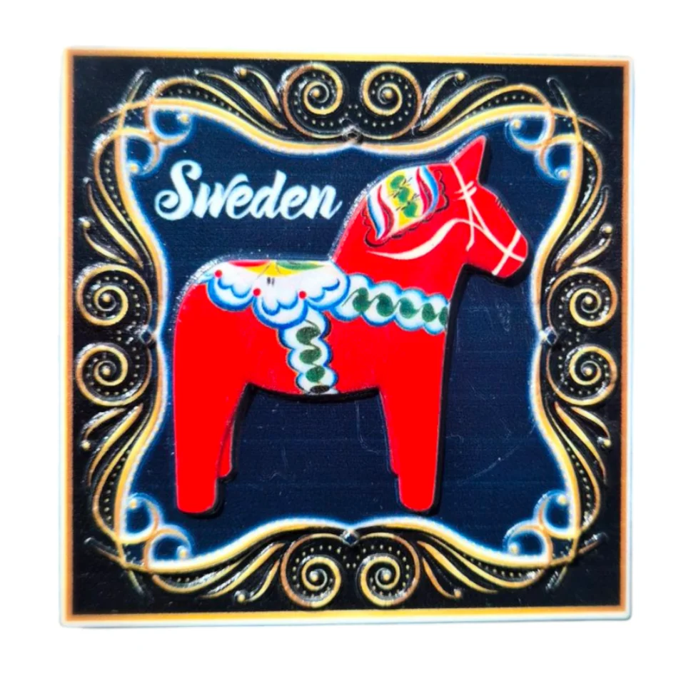 Colorful Sweden Dala Horse magnet on a decorative black background for souvenirs and collectors